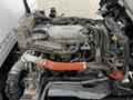 Close-up view of the engine of a 2018 Isuzu NRR showing various components including hoses and wiring