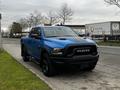 A blue 2021 RAM 1500 Classic pickup truck with black accents parked on a street