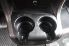 Close-up of a black plastic cup holder featuring two circular depressions for beverage containers in a 2015 Kenworth T660