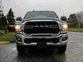 A 2020 RAM 3500 pickup truck is facing forward showcasing its bold grille and headlights with a shiny chrome bumper