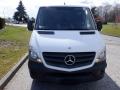 Front view of a white 2016 Mercedes-Benz Sprinter van featuring a prominent grille with the Mercedes logo and sleek headlights