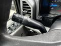 A close-up view of the windshield wiper control stalk in a 2017 Ford F-550 showing various settings and indicators