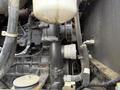 Close-up view of the engine components of a 2018 Doosan DL300 -5 including hoses and a pulley system