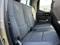 Interior view of the rear seating area of a 2023 Toyota Tundra featuring fabric upholstery and spacious seating arrangement