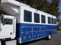 A 2008 Peterbilt PB340 truck with a blue and white exterior featuring large windows and storage compartments on the side