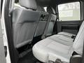 Interior view of the backseat of a 2015 Ford F-550 showing gray fabric seats and seatbelts without any occupants