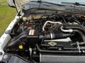 A close-up view of the engine compartment of a 2016 Ford F-550 showing various engine components and hoses