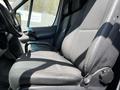 A 2012 Mercedes-Benz Sprinter van interior showing the driver's side seat with fabric upholstery and adjustable controls