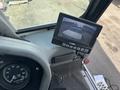 A monitor displaying a rear view camera feed inside a 2015 Global Street Sweeper's cabin with gauges and controls visible around it