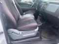 Interior view of a 2013 Ford F-150 showing two front seats with gray and black upholstery and a dashboard with controls and a stereo system