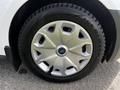 Close-up of a silver wheel with a blue Ford logo on a 2016 Ford Transit Connect featuring an Ice Blazer tire with visible tread patterns