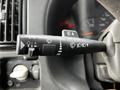 A control lever from a 2006 GMC C5000 with various symbols for headlights wipers and turn signals