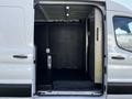 A 2022 Ford Transit with an open rear cargo area featuring a smooth black floor and a minimalist interior design