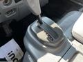 Interior view of a 2016 Isuzu NPR showing the gear shifter and console area with gear positions marked on the lever