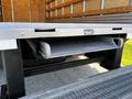 A metal step integrated into the side of a 2019 Ford Econoline van for easier access into the vehicle