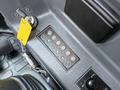 Control panel of a 2022 Hyundai R55-9A featuring buttons for various functions and a key ignition