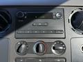 Dashboard controls of a 2008 Ford F-550 including radio and climate control knobs