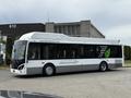 A 2018 Grande West Vicinity bus with a black and white exterior featuring a green leaf logo and text promoting sustainability
