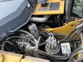 Close-up view of the engine components of a 2018 John Deere 350 showing various hoses valves and mechanical parts