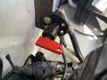A red battery disconnect switch with two gold terminals attached to wires in a 2016 Chevrolet Express engine compartment