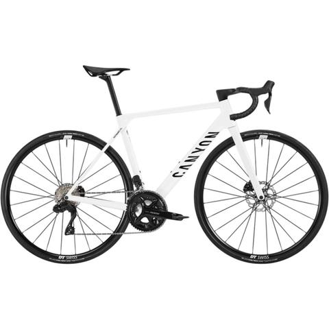 2026 Canyon Ultimate CF 7 Di2 road bike in white with sleek design features drop handlebars and high-performance components including disc brakes and lightweight wheels