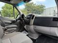 Interior view of a 2012 Mercedes-Benz Sprinter with a driver’s seat and dashboard showing controls and a gear shift