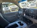 Interior view of a 2013 Chevrolet Silverado 1500 featuring a driver's seat dashboard and center console with cup holders