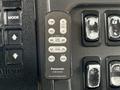 A Panasonic car audio remote control with buttons for power volume source file mute and band as well as navigation controls for tuning and folder selection