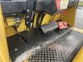 A close-up view of the control panel of a 2010 Hyster S80XLBCS featuring foot pedals ignition switches and wiring with a textured metal platform