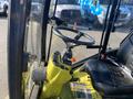 Interior view of a 2010 Kubota F3680 featuring a steering wheel seat and control panel with various levers and buttons