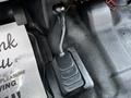 The image shows the gear shift lever of a 2016 Ford F-550 with a black base and handle positioned on a textured surface