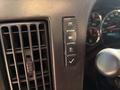 A close-up view of the interior controls of a 2017 Chevrolet Express, featuring buttons for light functions, traction control, and a dashboard display
