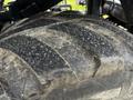 Close-up of a large, textured tire of a 2020 Pottinger Impress featuring distinct tread patterns and surface wear