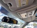 Interior view of a 2006 Land Rover LR3 featuring a rearview mirror and overhead console with lights and warning labels