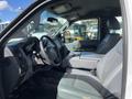 Interior view of a 2013 Ford F-250 SD featuring gray leather seats and a black dashboard with controls and a center console