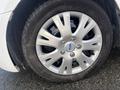 A close-up of a silver alloy wheel from a 2017 Ford Transit Connect featuring distinct spokes and a Ford logo in the center