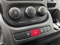 The control panel of a 2021 RAM Promaster featuring climate control knobs and various function buttons in black and red colors