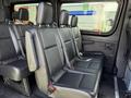 Interior of a 2019 Mercedes-Benz Sprinter showing black leather seats in a row with seat belts attached
