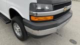 A 2017 Chevrolet Express Quigley 4x4 van showcasing its front bumper and grille with chrome trim and an orange marker light