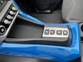 An interior console feature of a 2020 Polaris Slingshot with a gear shift selector showing the positions R N D M