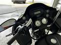 A 2013 Harley Davidson Flhtrx motorcycle with a black dashboard featuring gauges and a digital display along with chrome accents and handlebars