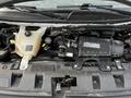Engine compartment of a 2017 Chevrolet Express showcasing the engine components including the air intake and coolant reservoir