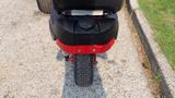 A 2014 Ferris Mower ISX 800 viewed from the rear showing the black and red chassis and wheel with textured tread