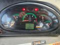 The dashboard of a 2015 Case 590SN showing various gauges for speed, engine temperature, fuel level, and an hour meter reading 006473.7