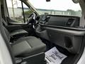 Interior view of a 2020 Ford Transit featuring two front seats a dashboard with controls and a touchscreen display