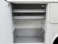 2006 Ford F-450 truck interior showing an empty cargo space with two horizontal shelves and a clean gray floor
