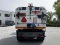 A 2012 Autocar Xpert truck with a rear view displaying safety signs a warning triangle and a caution message about visibility and driving orientation