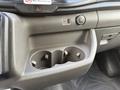 Interior view of a 2021 Ford Transit showing a dashboard with cup holders a USB port and a power outlet