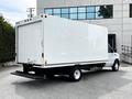 A white 2021 Ford E-450 box truck with a blank rear and a loading ramp visible at the back
