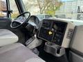 Interior view of a 2011 International WorkStar featuring a steering wheel dashboard controls and gear shift with a cup holder